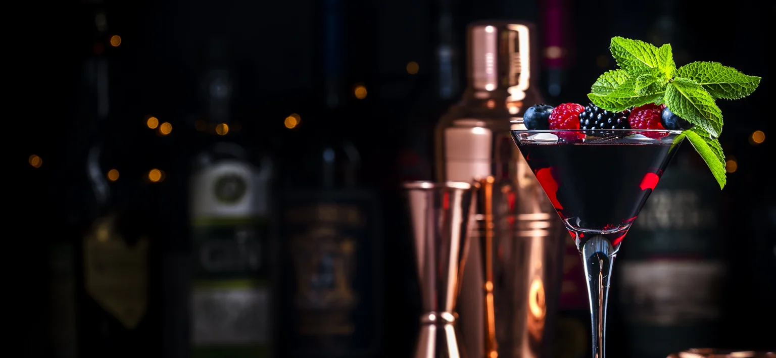 A cocktail with fresh berries and mint